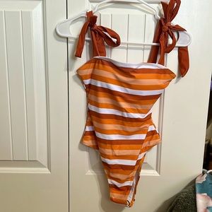 Pink lily one piece bathing suit size small. Never worn but couldn’t return.